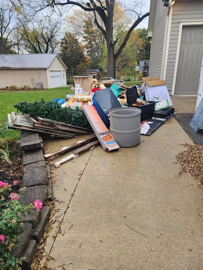 Dumpster being loaded with debris for Commercial Dumpster Rental in Noble
